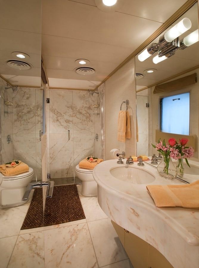 a bathroom with a sink toilet and a mirror aboard MONTEGO Yacht for Sale