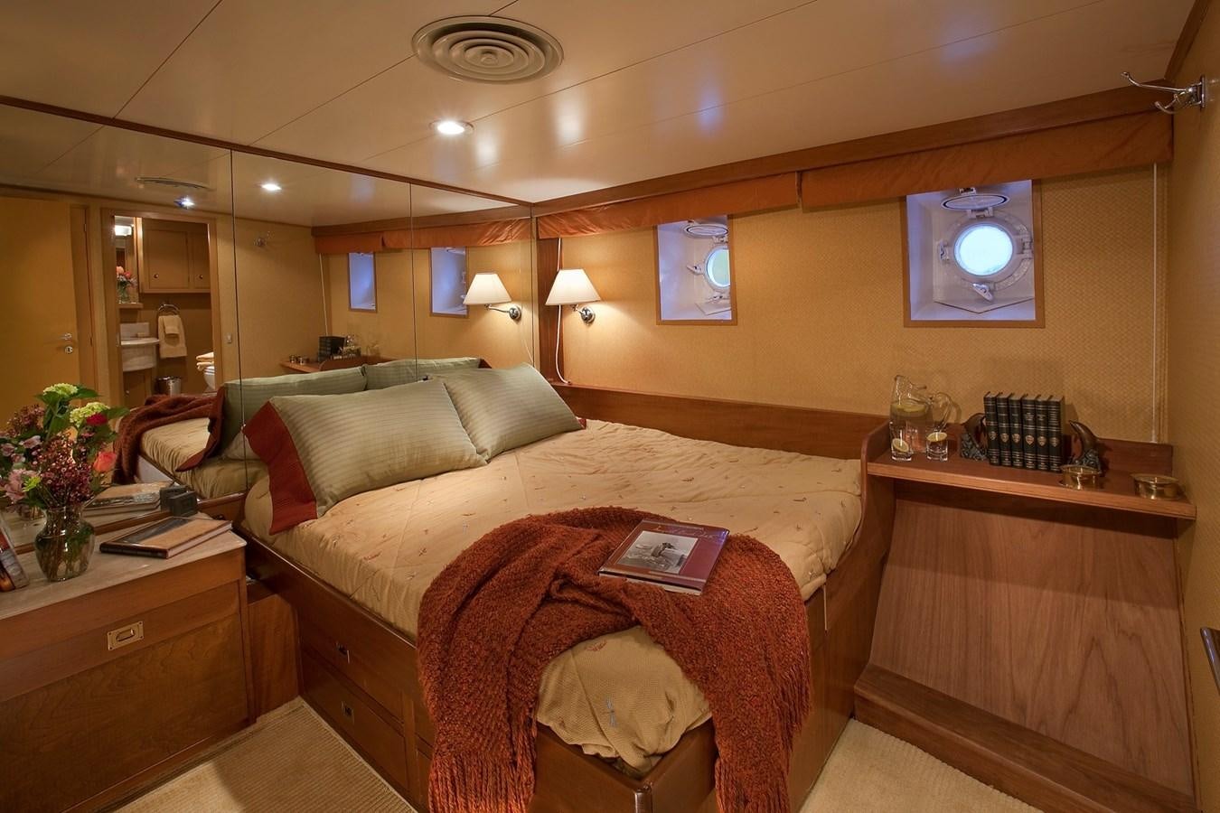 a bedroom with a bed and a desk aboard MONTEGO Yacht for Sale