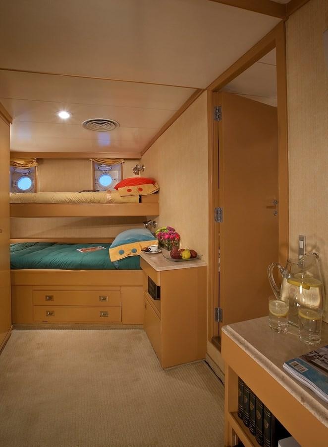 a room with a bunk bed and a table aboard MONTEGO Yacht for Sale