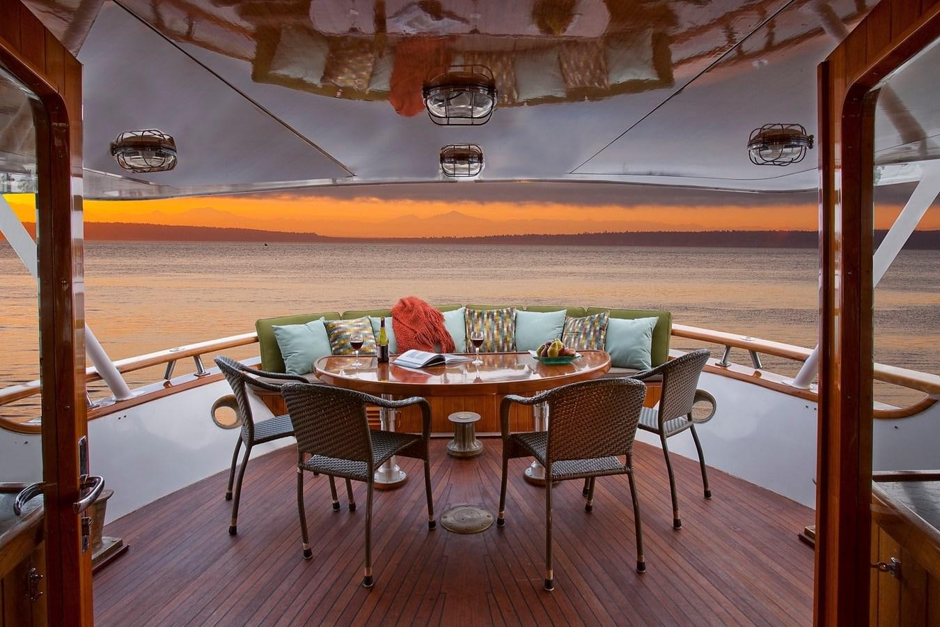 a table and chairs on a balcony aboard MONTEGO Yacht for Sale