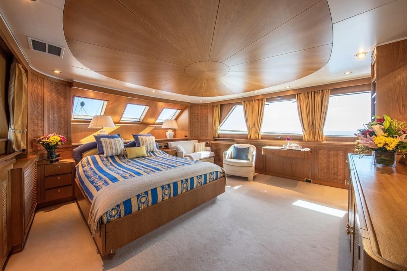 a room with a bed and a chair aboard MONACO Yacht for Sale