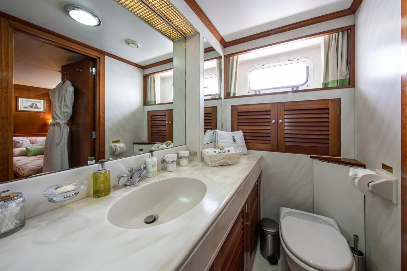 a person taking a picture of themselves in a bathroom mirror aboard MONACO Yacht for Sale