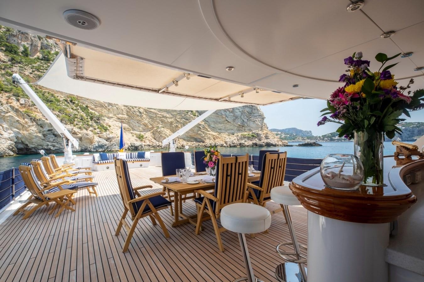 a room with tables and chairs aboard MONACO Yacht for Sale