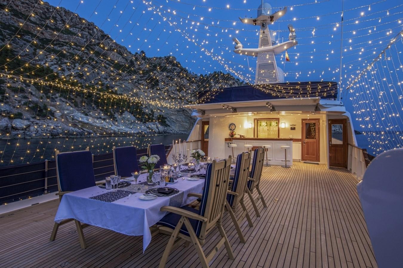 a room with a table and chairs aboard MONACO Yacht for Sale