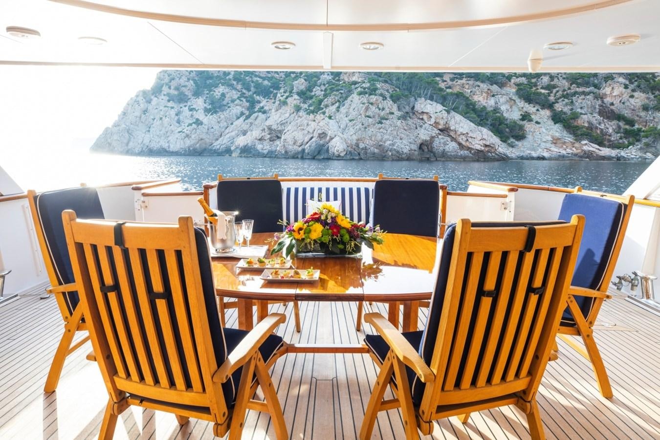 a table and chairs on a balcony aboard MONACO Yacht for Sale