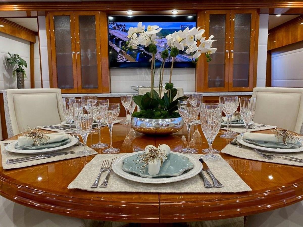a table set with plates and glasses aboard BRANDI WINE Yacht for Sale