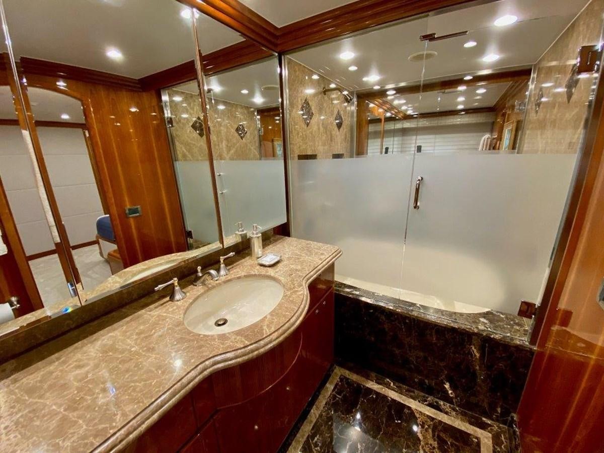 a bathroom with a countertop sink and a large mirror aboard BRANDI WINE Yacht for Sale