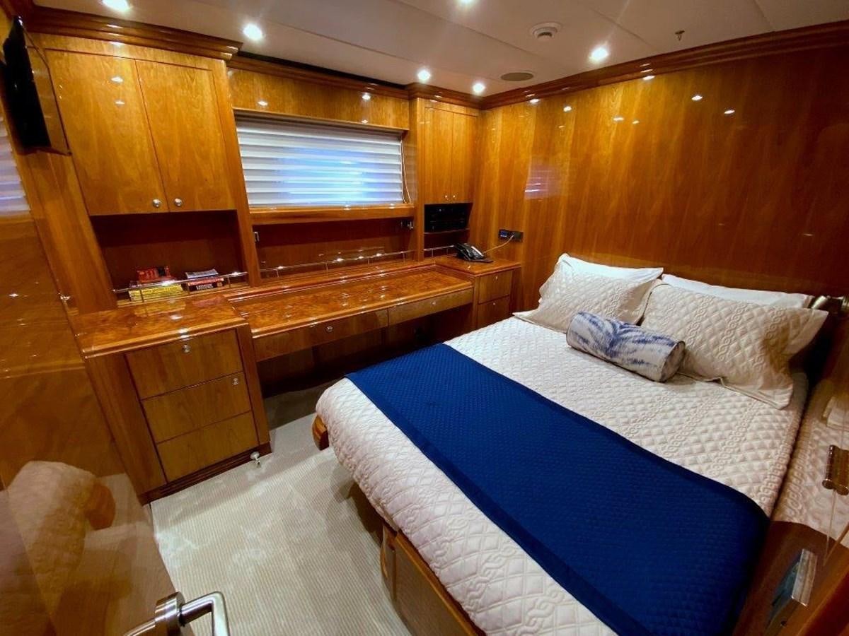 a bedroom with a bed and a desk aboard BRANDI WINE Yacht for Sale