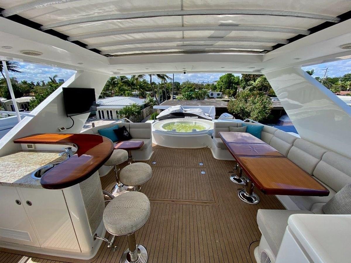 a room with a deck and a pool aboard BRANDI WINE Yacht for Sale