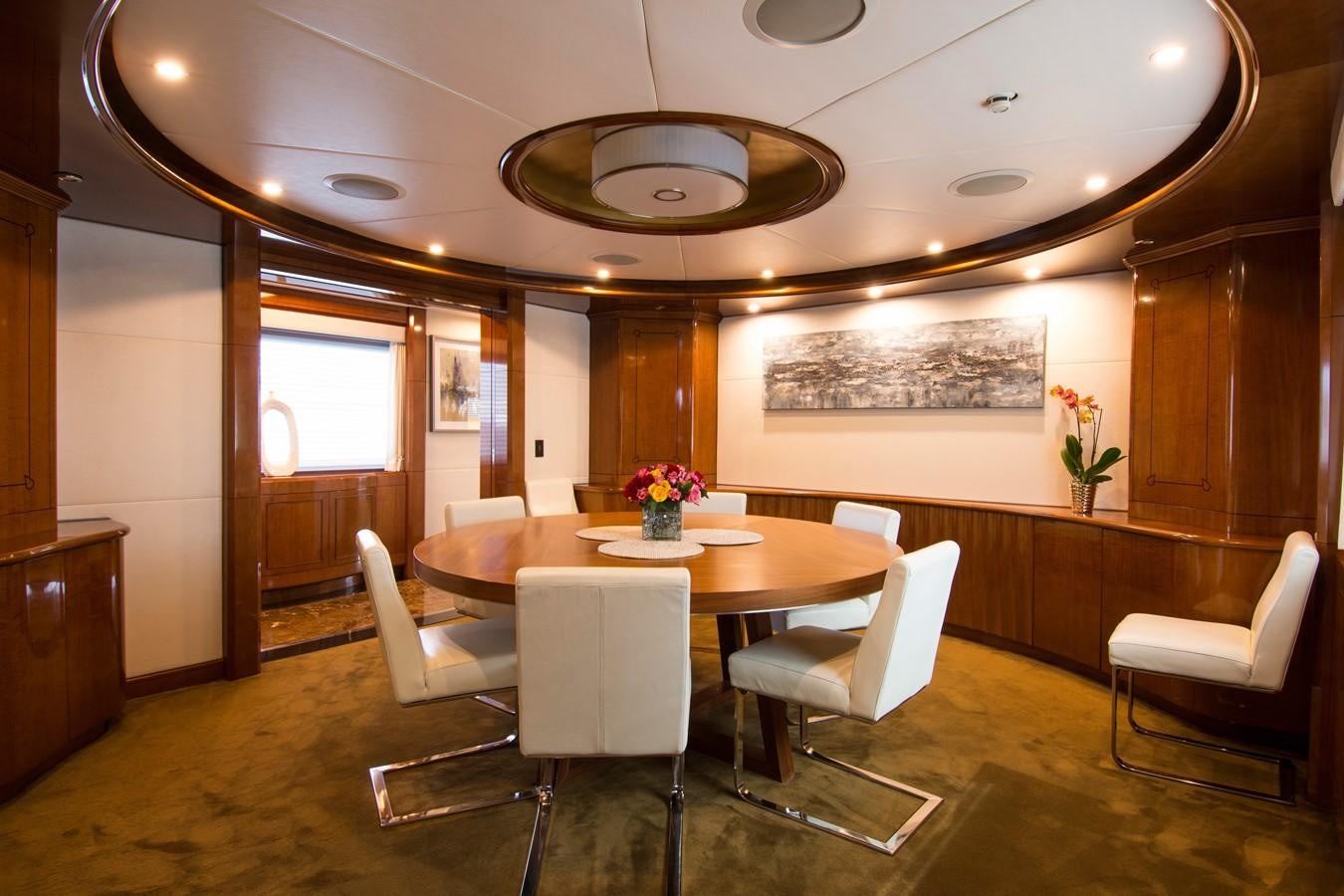 a room with a table and chairs aboard HORIZONS II Yacht for Sale