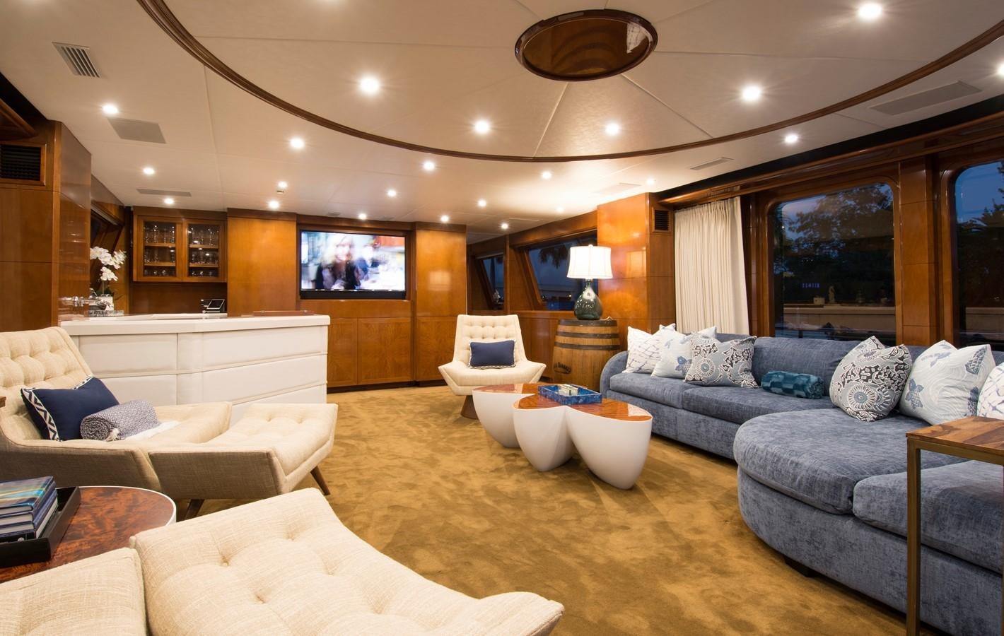 a living room with a large sofa and a large screen aboard HORIZONS II Yacht for Sale