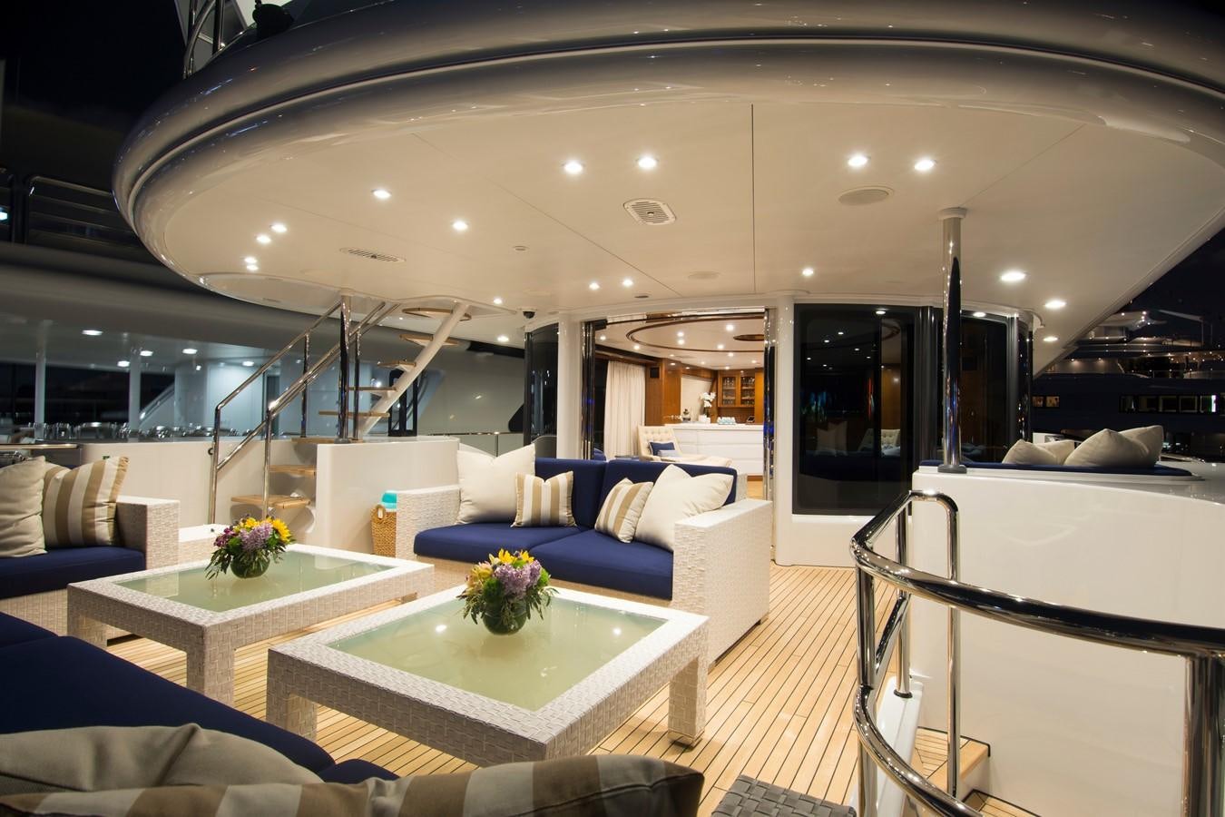 a living room with a large glass table and a large window aboard HORIZONS II Yacht for Sale