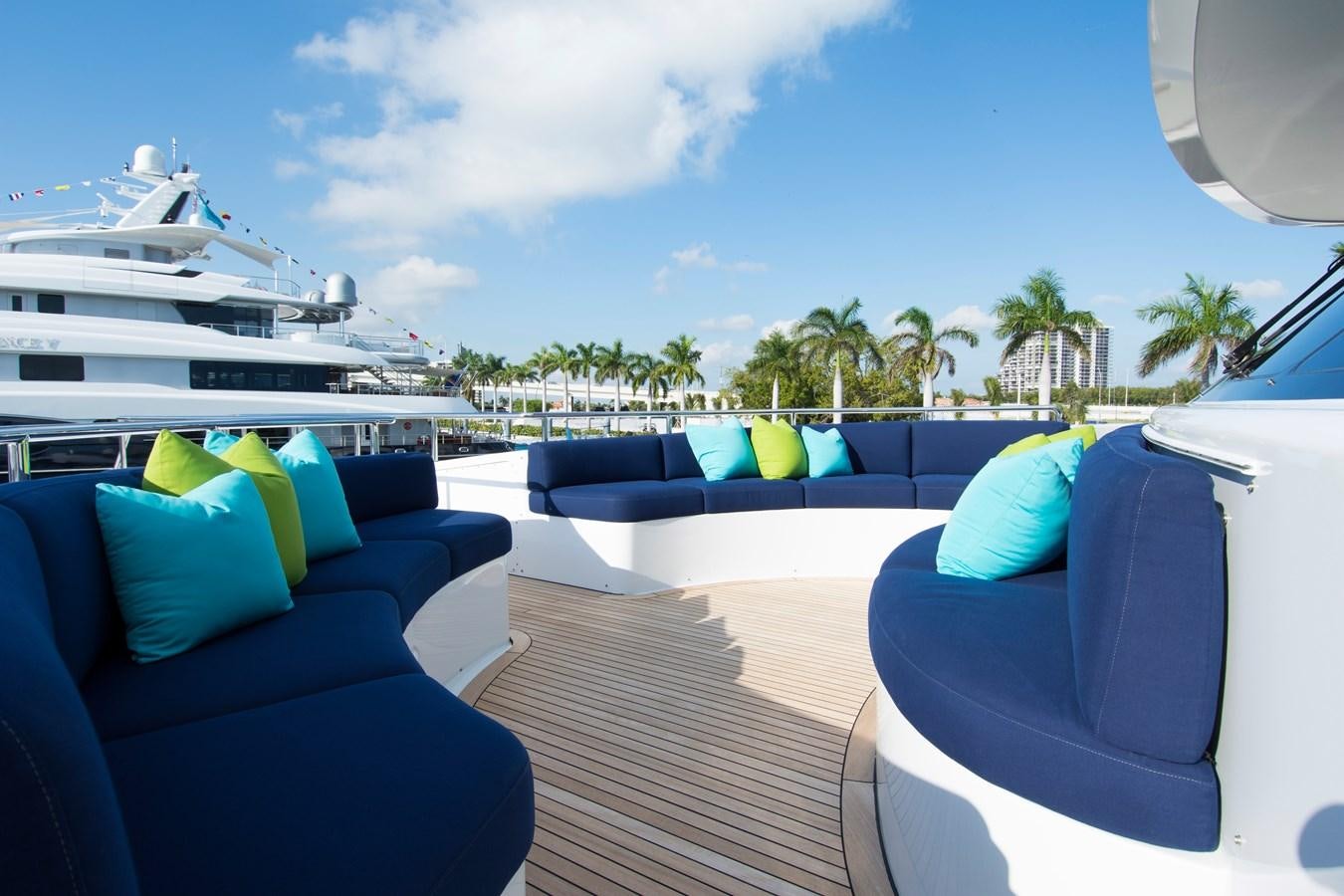 a deck with chairs and a large cruise ship in the background aboard HORIZONS II Yacht for Sale