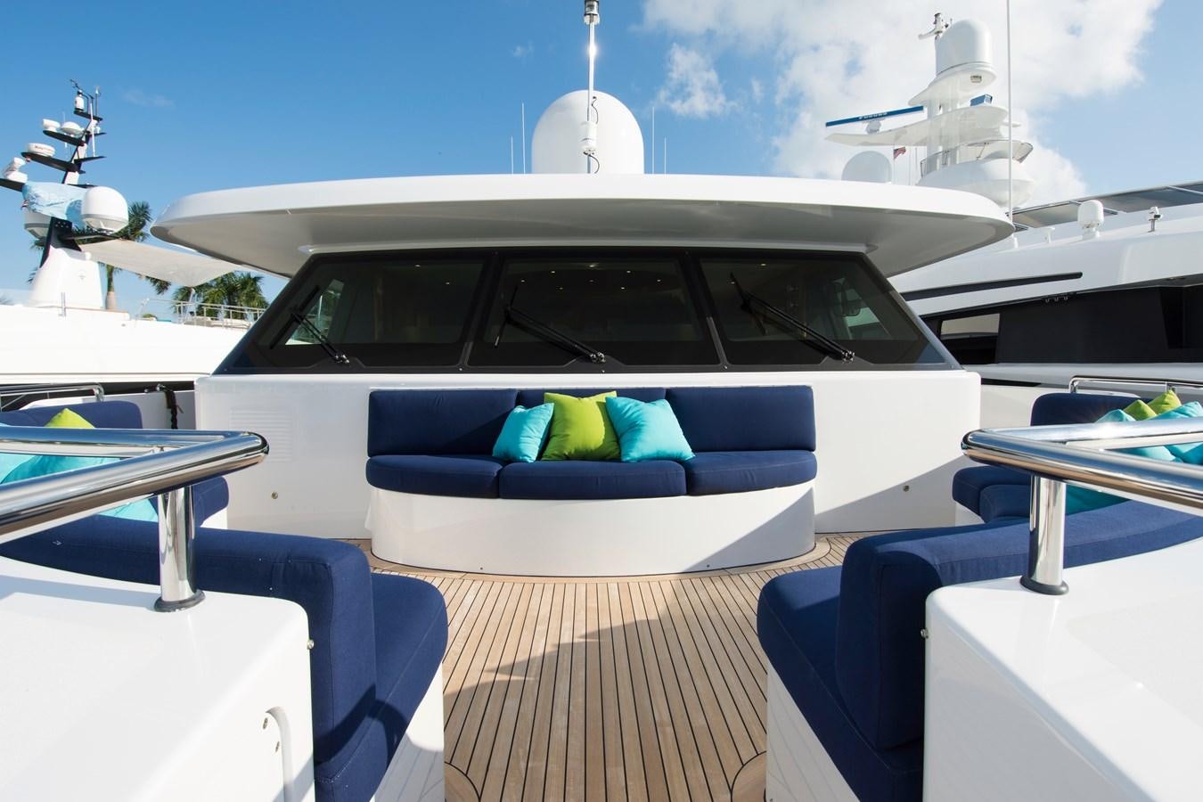 a white car with a blue pillow on a wooden deck aboard HORIZONS II Yacht for Sale