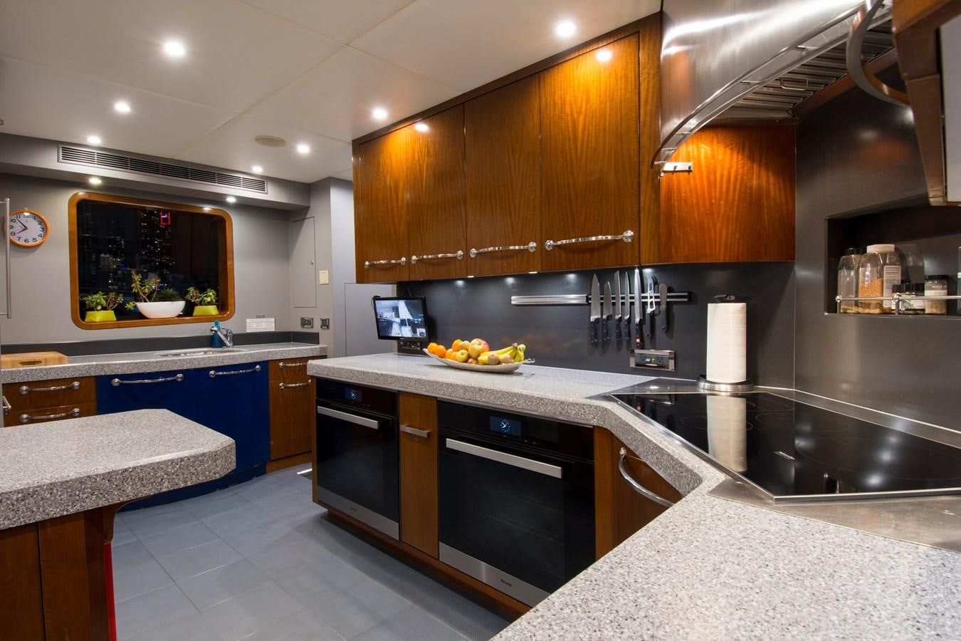 a kitchen with black appliances aboard HORIZONS II Yacht for Sale