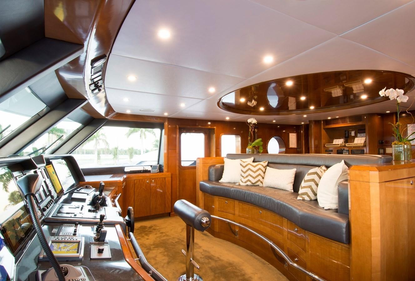 a room with a couch and a table with chairs aboard HORIZONS II Yacht for Sale