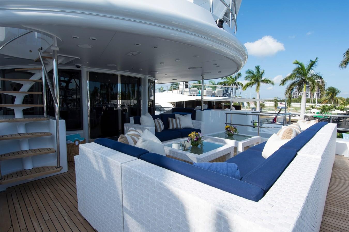 a large white lounge chair next to a pool table and a large white lounge chair aboard HORIZONS II Yacht for Sale