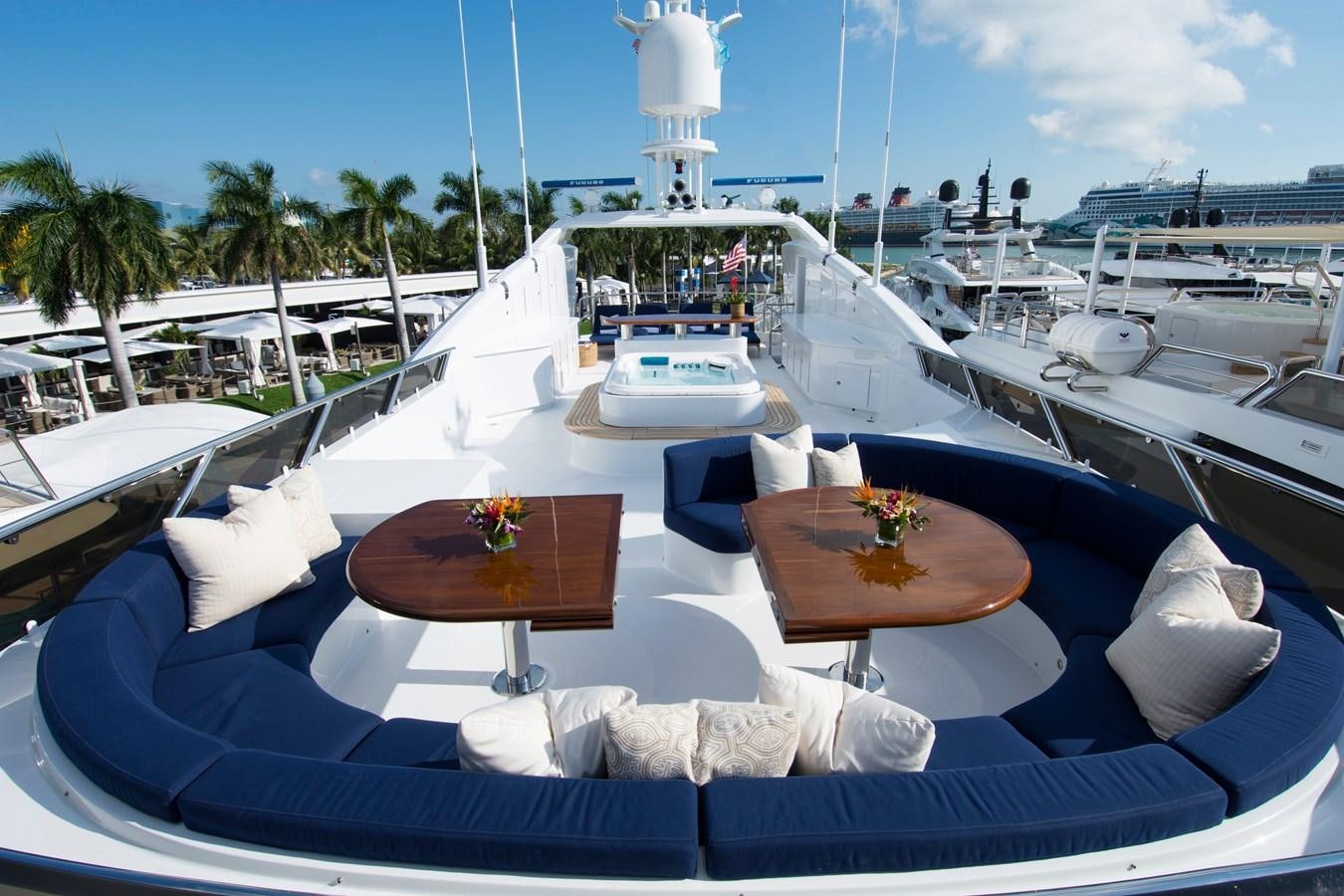 a boat with a table and chairs on it aboard HORIZONS II Yacht for Sale