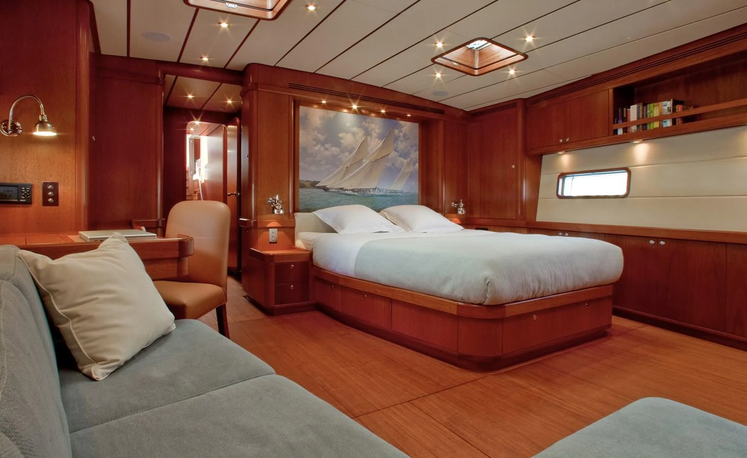 a room with a bed and a chair aboard NILAYA Yacht for Sale
