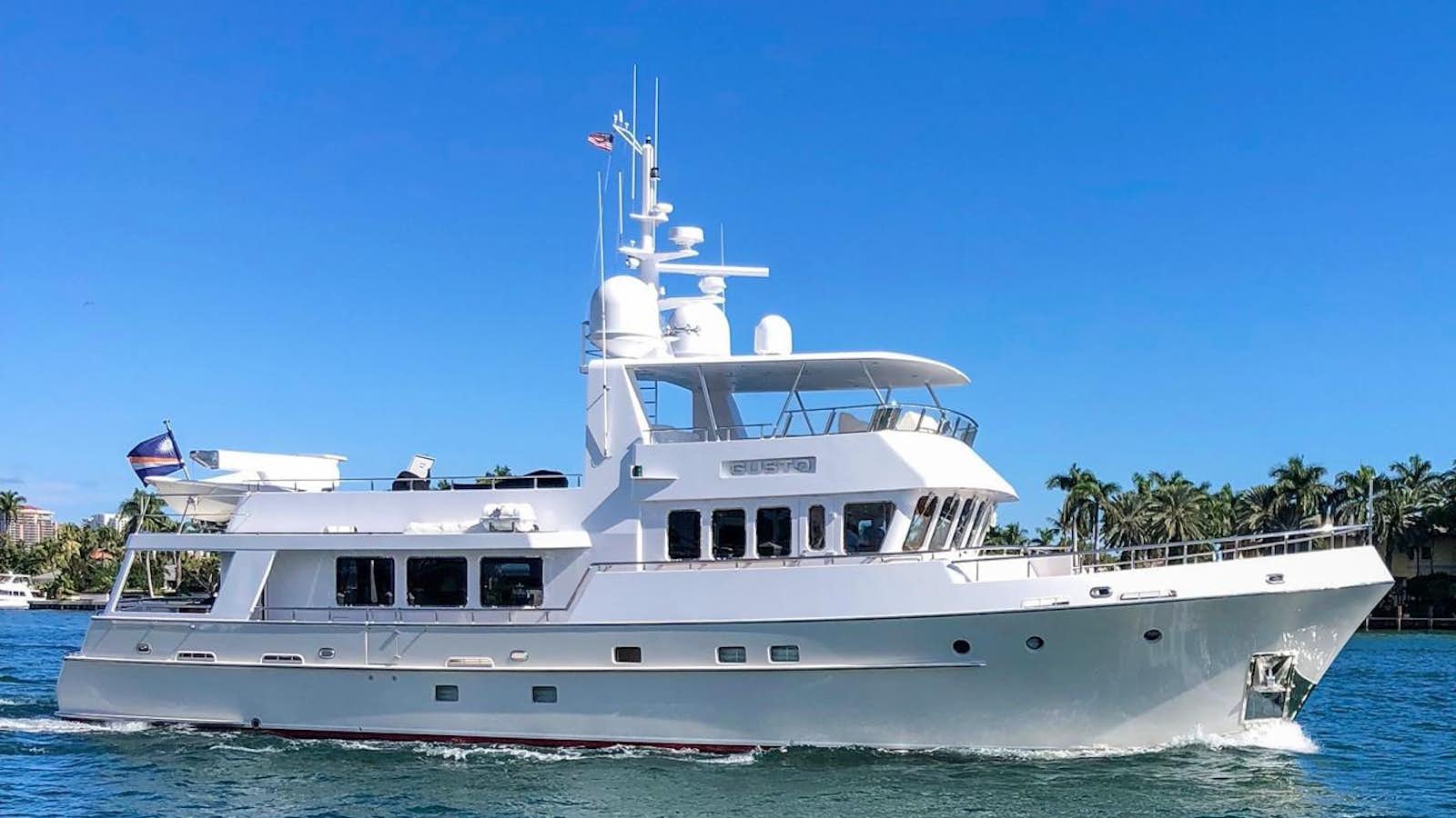 a large white boat in the water aboard GUSTO Yacht for Sale