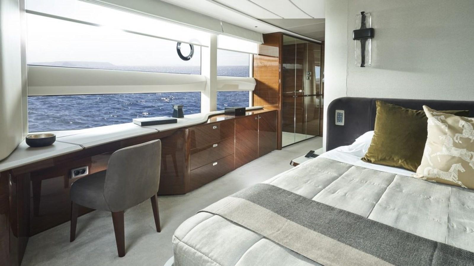a bedroom with a bed and a desk aboard PRINCESS X95/03 Yacht for Sale