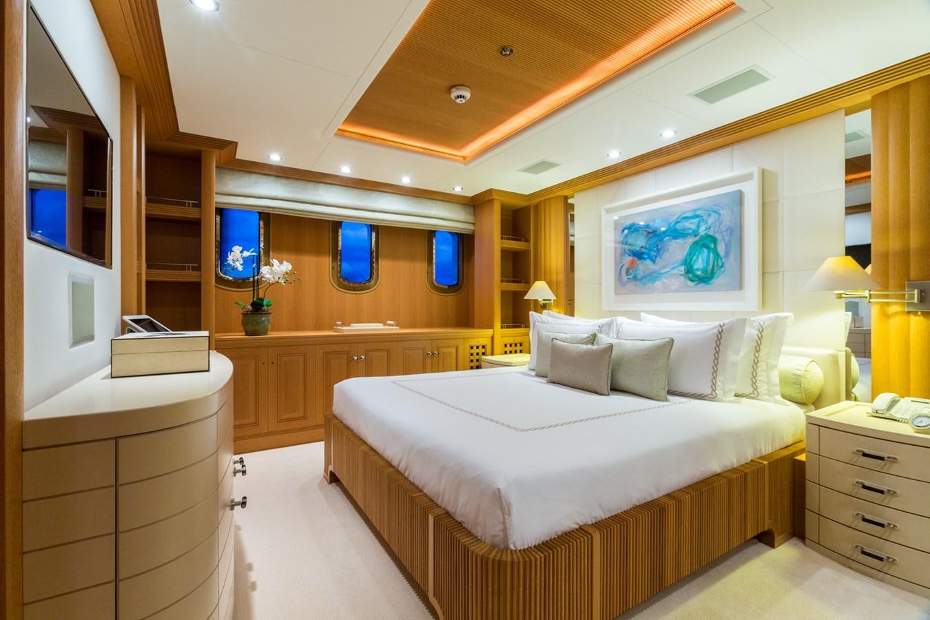 a bedroom with a bed and a mirror aboard ADVENTURE Yacht for Sale