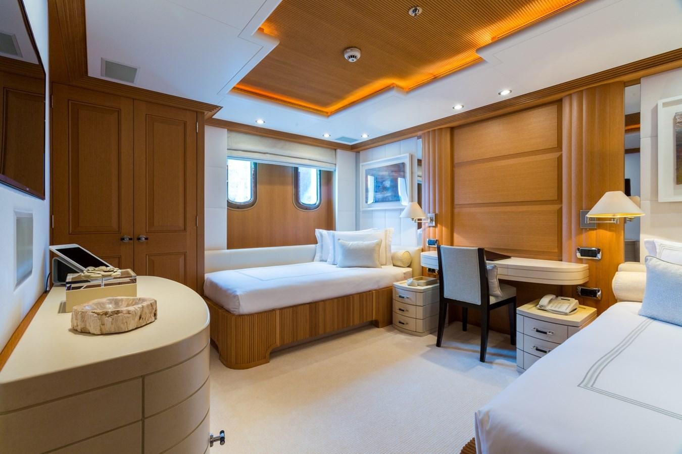 a bedroom with a bed and a desk aboard ADVENTURE Yacht for Sale