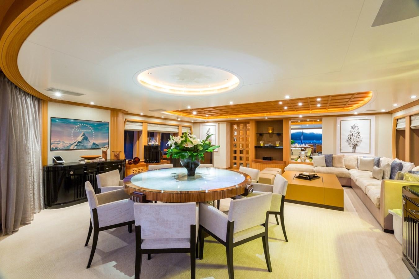 a large living room with a table and chairs aboard ADVENTURE Yacht for Sale