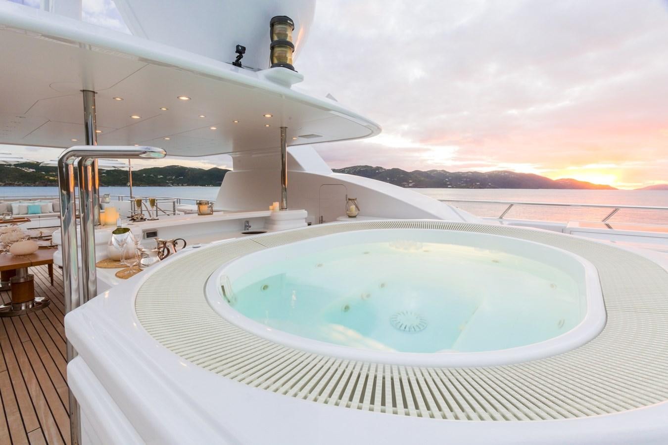 a large swimming pool on a deck aboard ADVENTURE Yacht for Sale