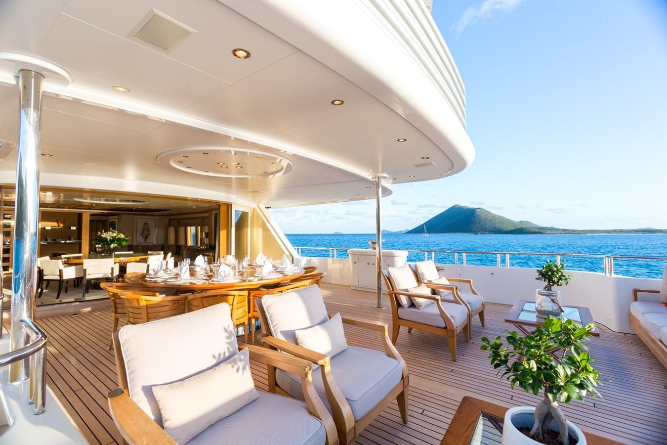a room with a table chairs and a plant on the table aboard ADVENTURE Yacht for Sale