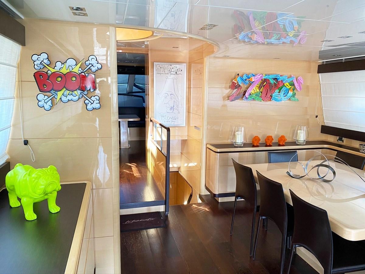 a room with tables and chairs aboard LIBERATA Yacht for Sale