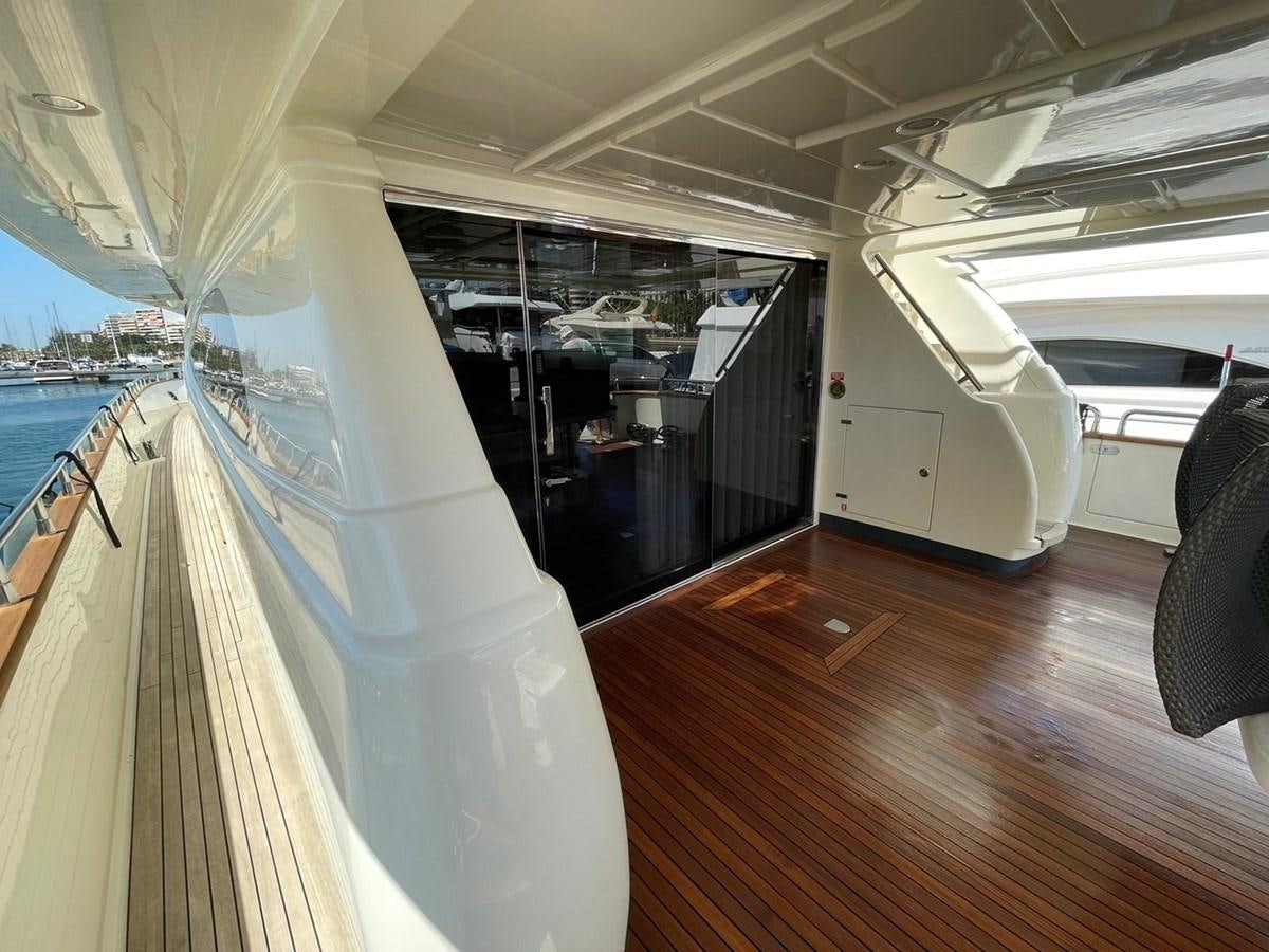 a room with a balcony and a view of the water aboard LIBERATA Yacht for Sale