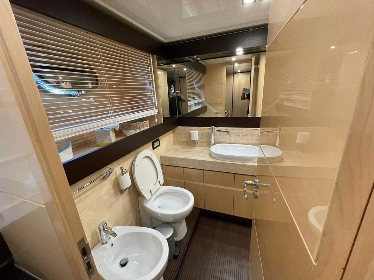 a bathroom with a sink toilet and a mirror aboard LIBERATA Yacht for Sale