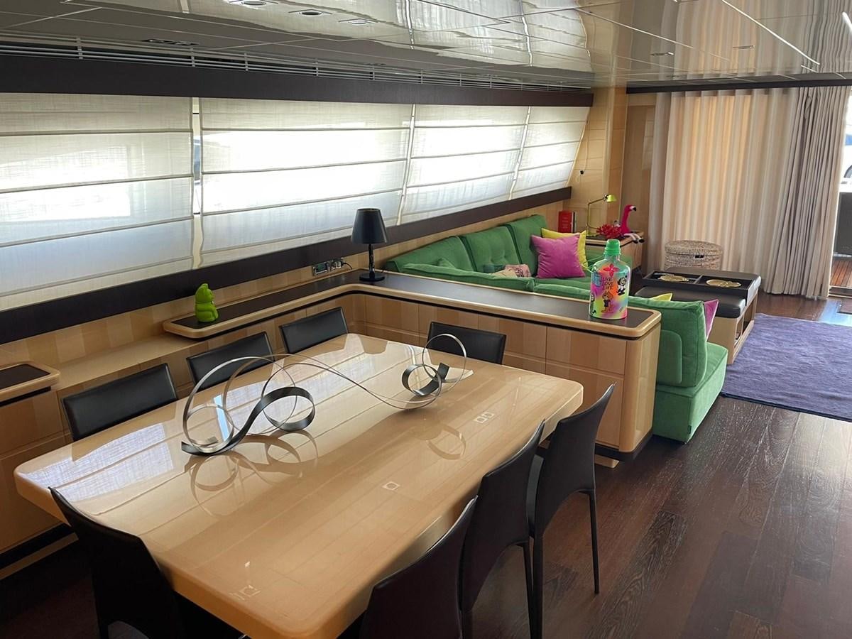 a room with a table and chairs aboard LIBERATA Yacht for Sale