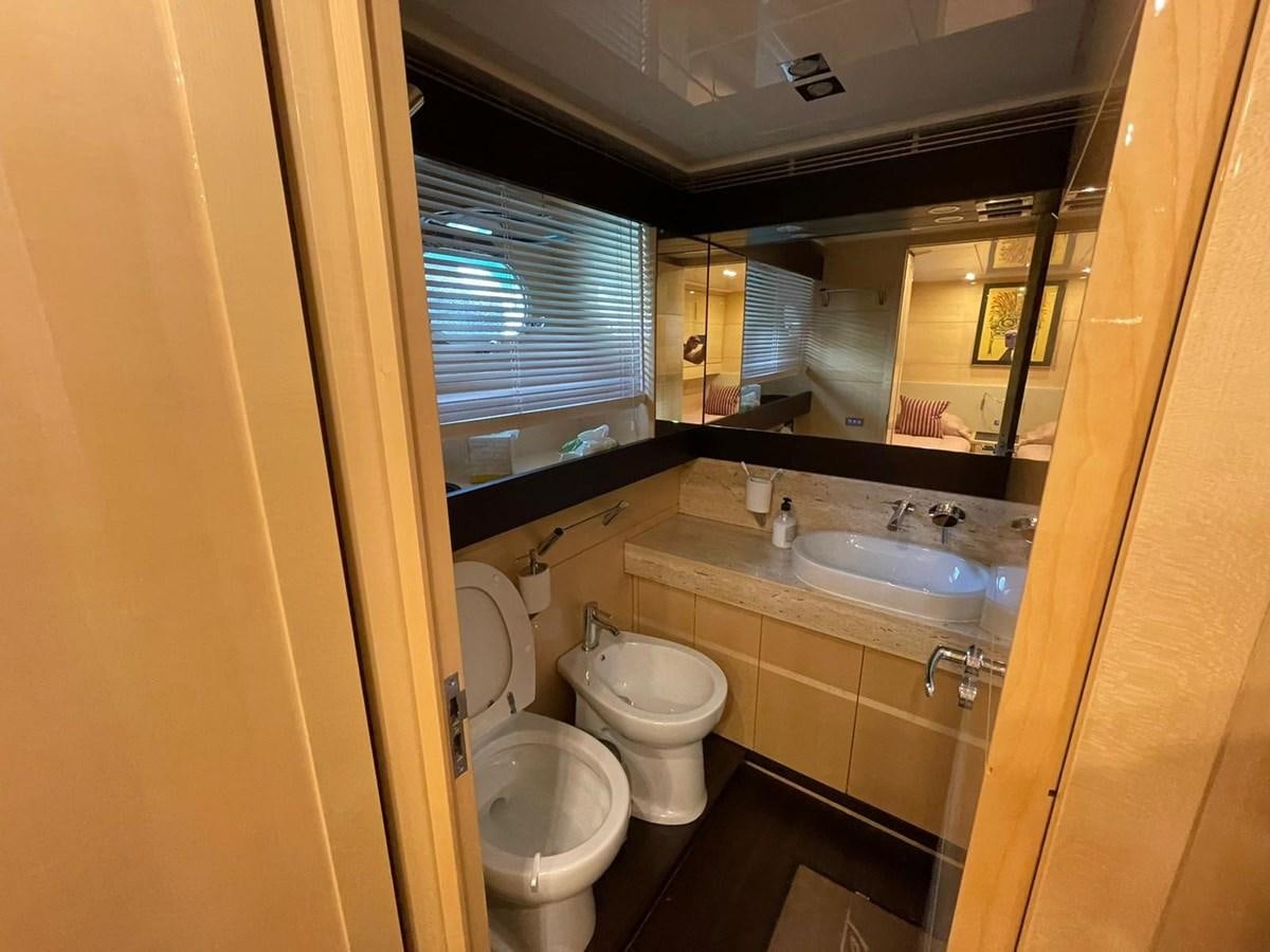 a bathroom with a sink toilet and a mirror aboard LIBERATA Yacht for Sale