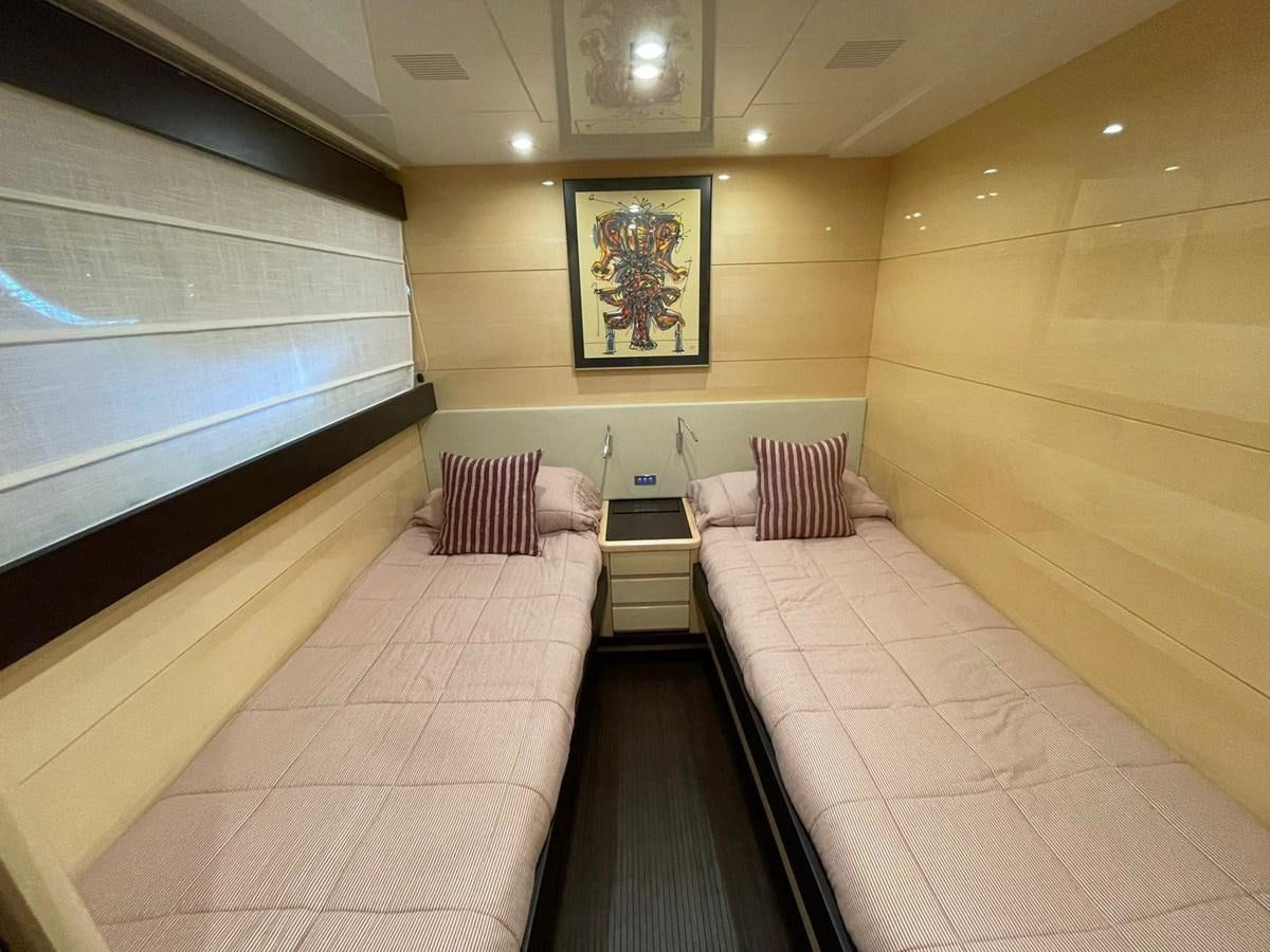 a room with a couch and a television on the wall aboard LIBERATA Yacht for Sale