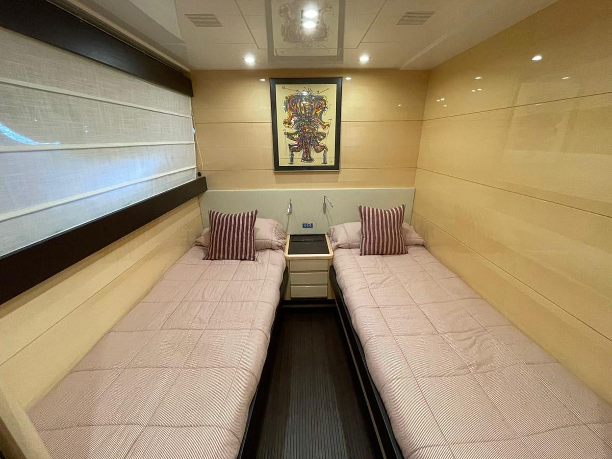 a room with a bed and a window aboard LIBERATA Yacht for Sale