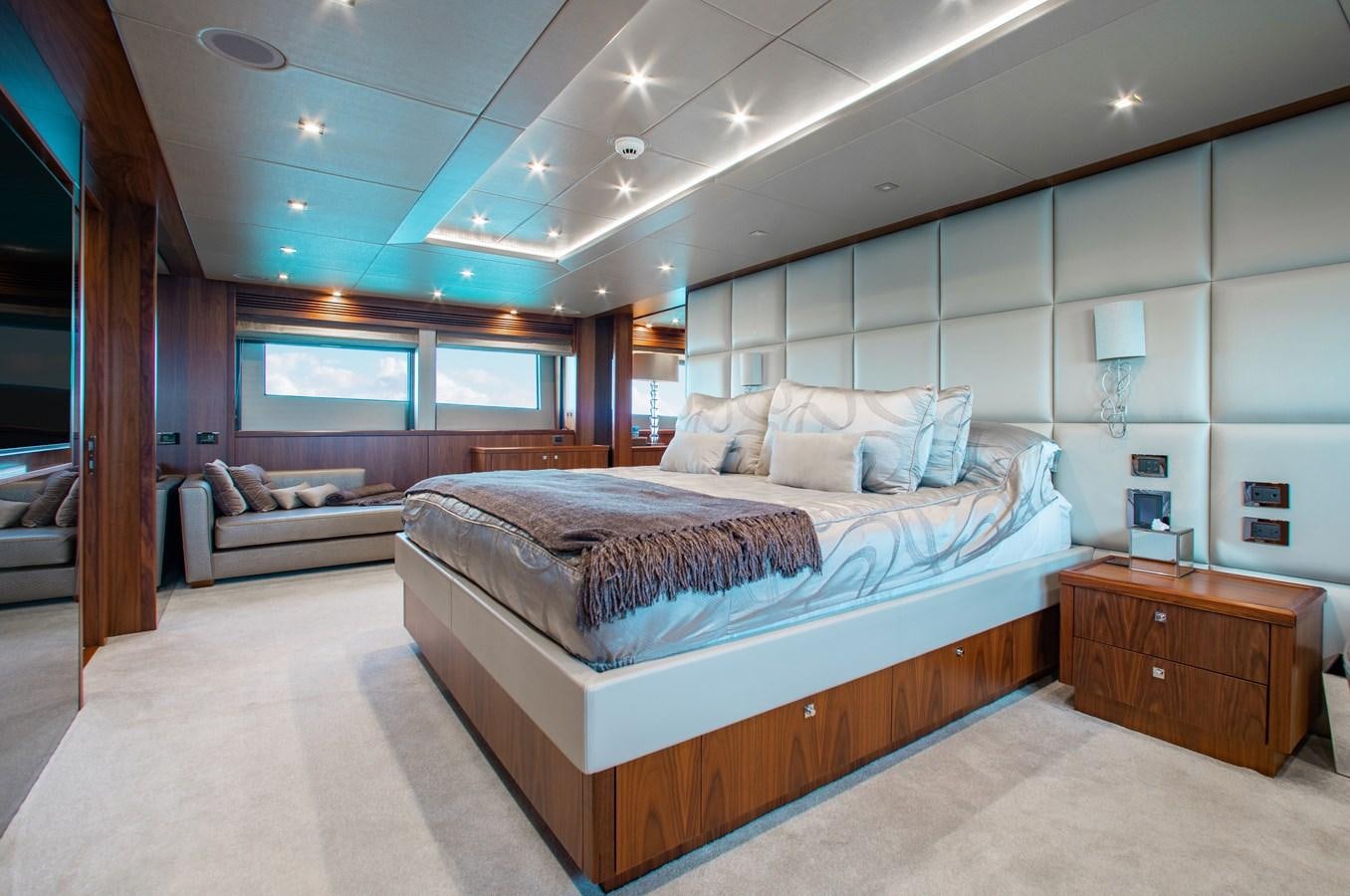 a bedroom with a bed and a couch aboard MARIN Yacht for Sale