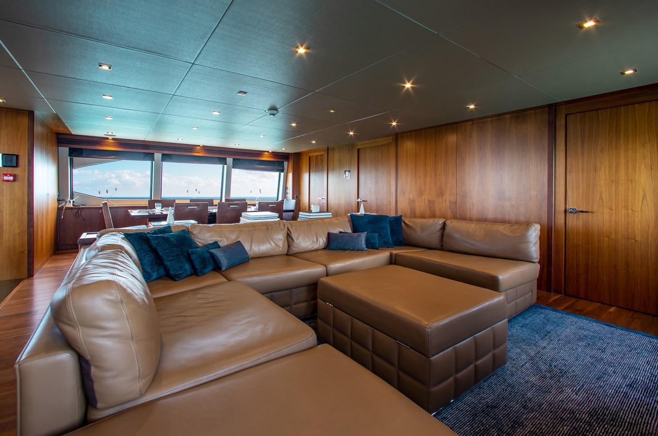 a living room with a couch and a wood wall aboard MARIN Yacht for Sale