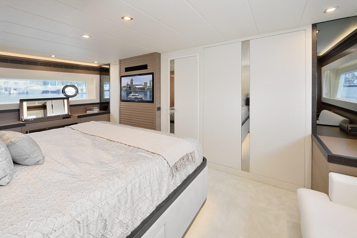a bedroom with a bed and a television aboard E81 Yacht for Sale