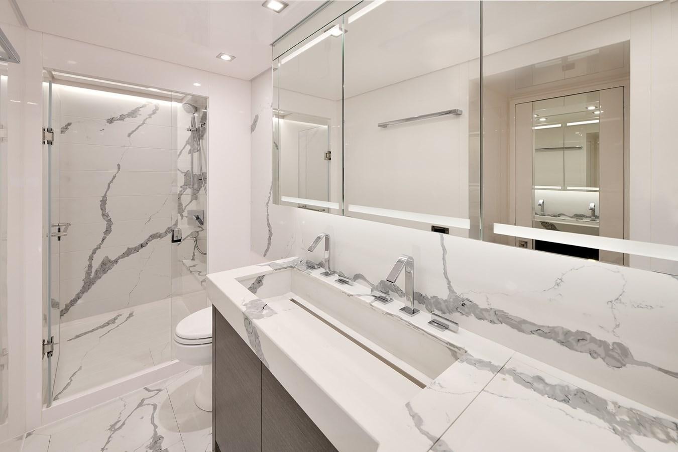 a bathroom with a tub sink and toilet aboard E81 Yacht for Sale