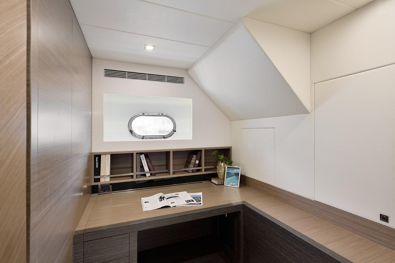a room with a desk and a tv on the wall aboard E81 Yacht for Sale