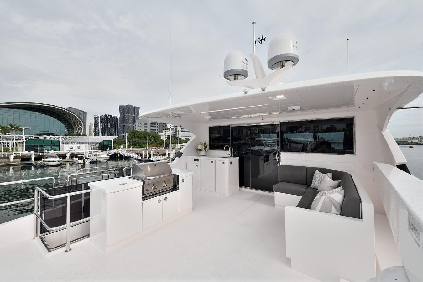 a room with a view of a city and a large pool aboard E81 Yacht for Sale