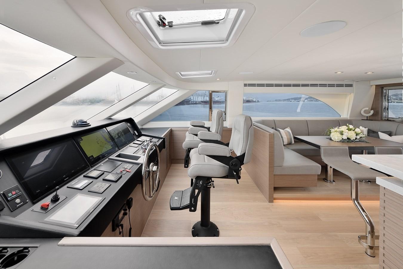a room with a table and chairs aboard E81 Yacht for Sale