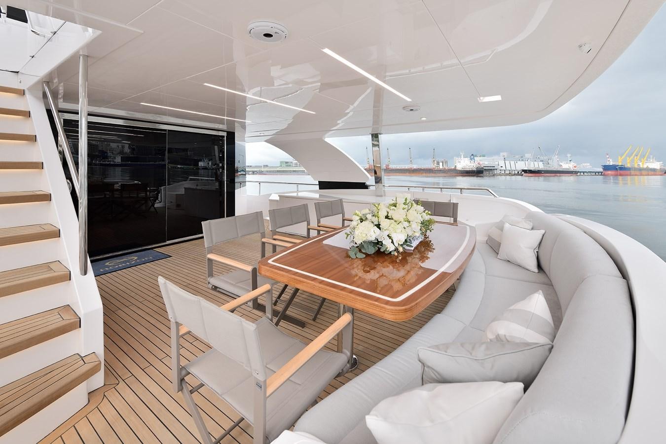 a room with a table chairs and a couch aboard E81 Yacht for Sale