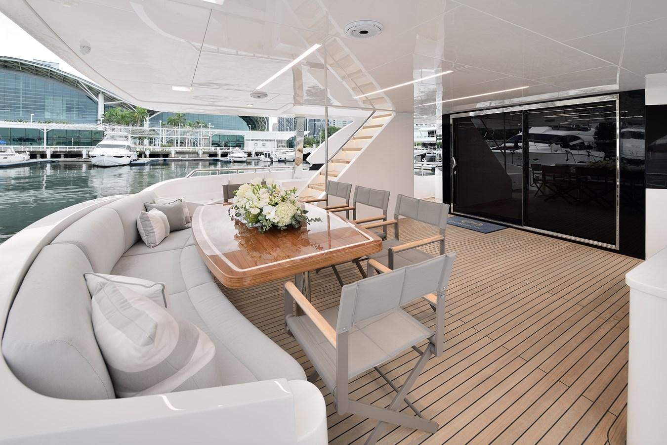 a room with a table chairs and a large window aboard E81 Yacht for Sale