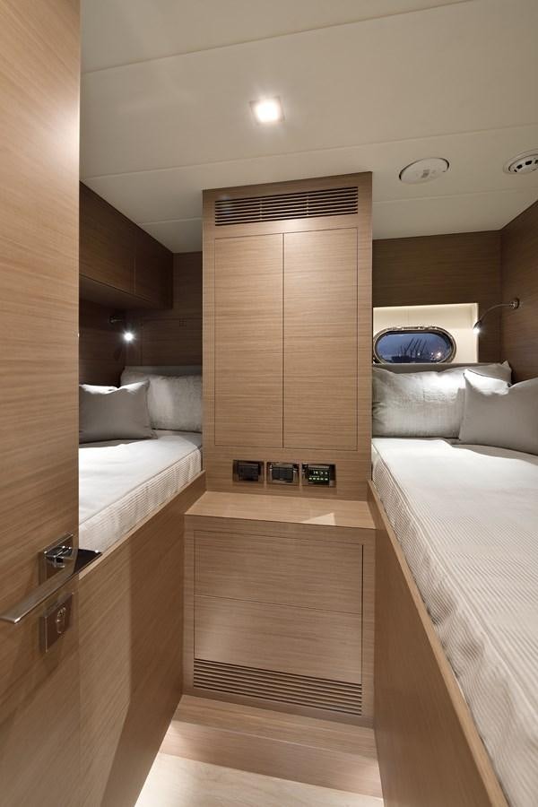 a room with a bed and a wood door aboard E81 Yacht for Sale