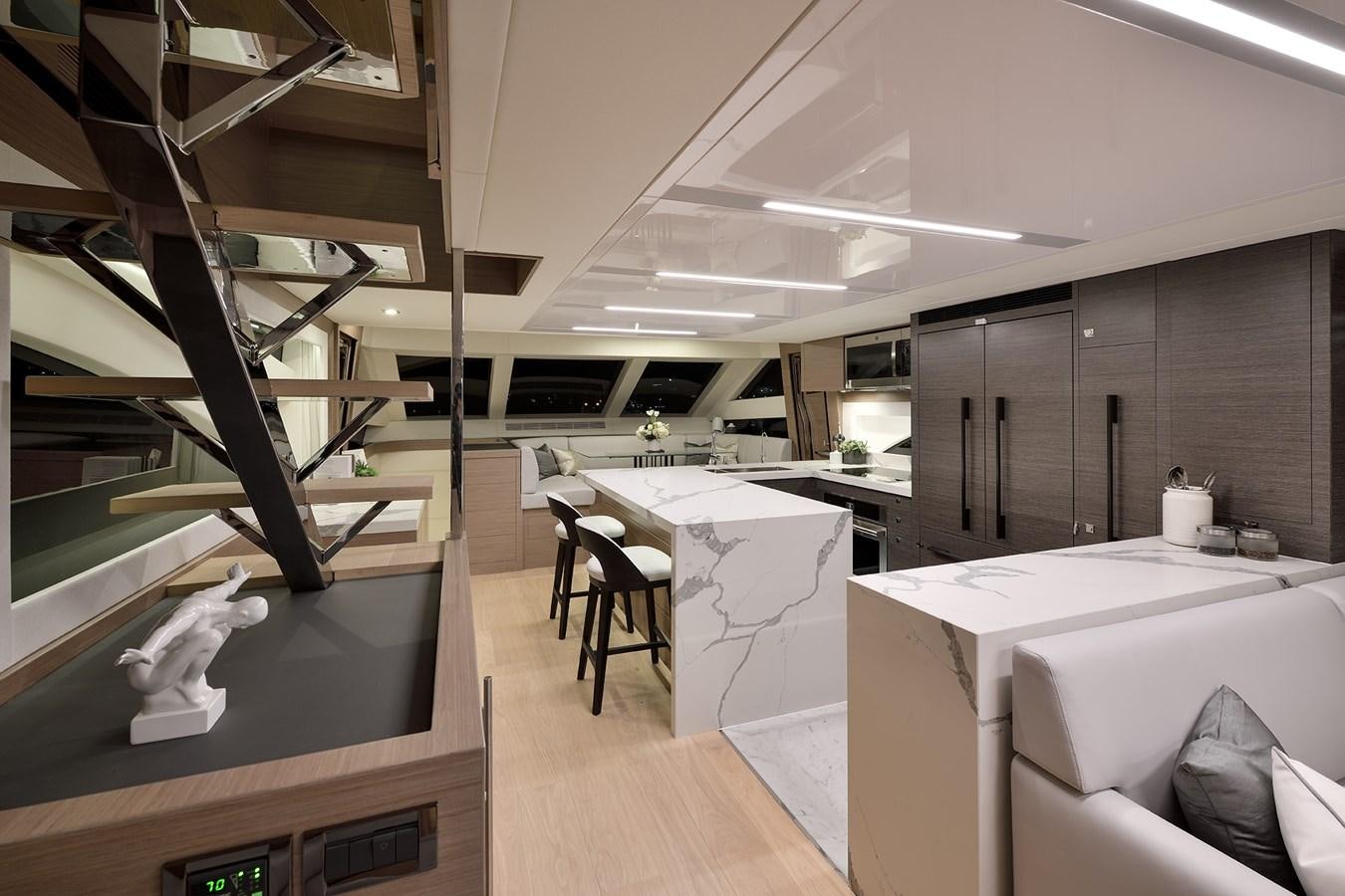 a room with a table and chairs aboard E81 Yacht for Sale