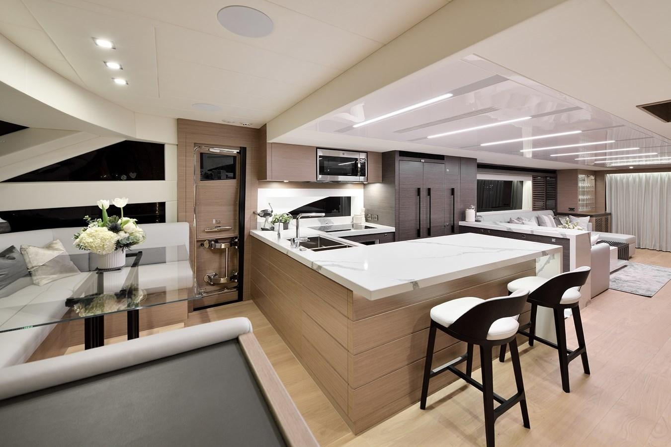 a modern kitchen with white cabinets aboard E81 Yacht for Sale