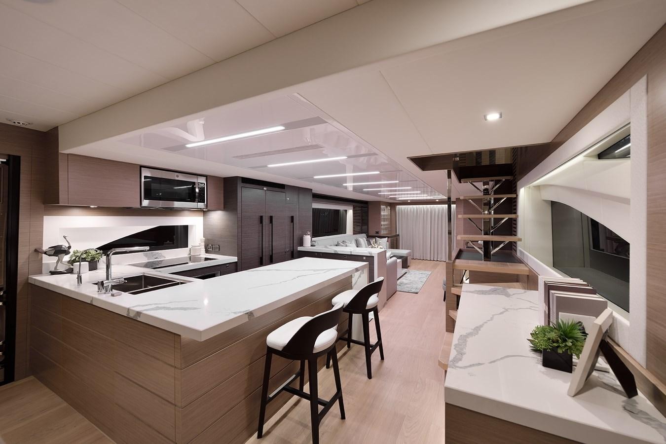 a modern kitchen with white cabinets aboard E81 Yacht for Sale